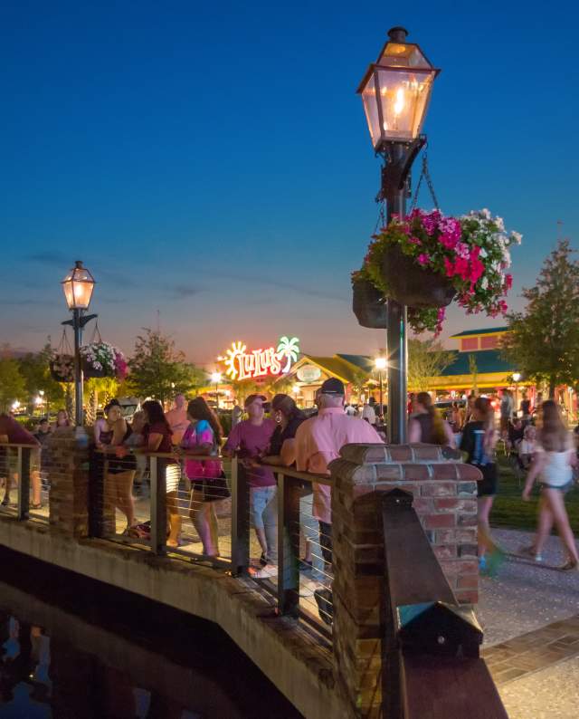 Crowd Walking Barefoot Walkway at Night
