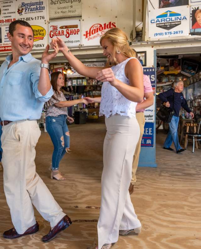 2 shaggers dancing in front of a crowd.