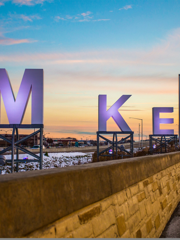 big MKE letters by airport, sunrise