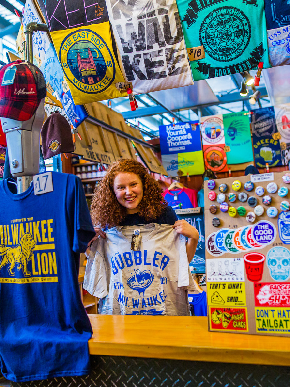 woman smiling in clothing merchandise booth