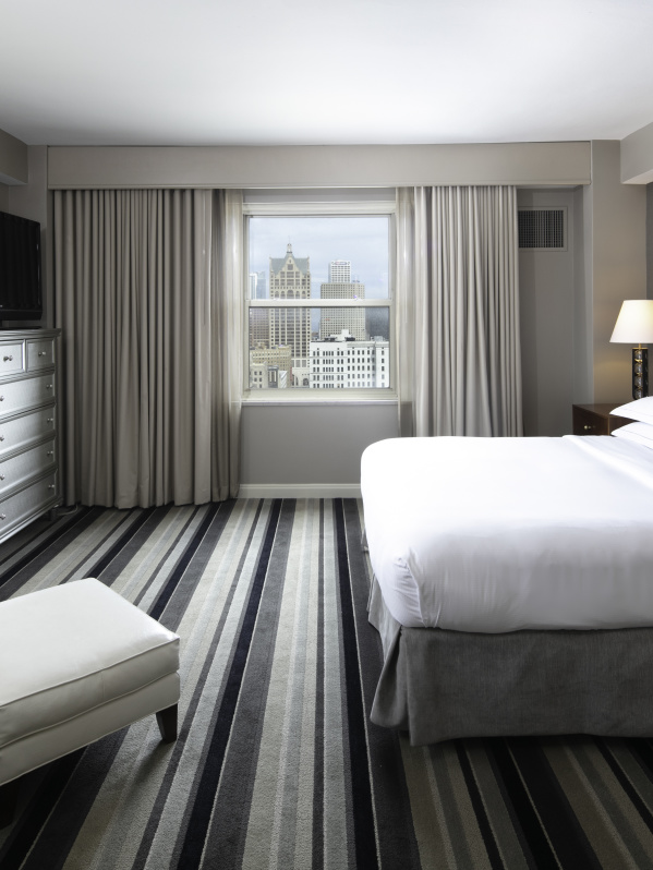 interior of a hotel room with Milwaukee Skyline prominent outside the window