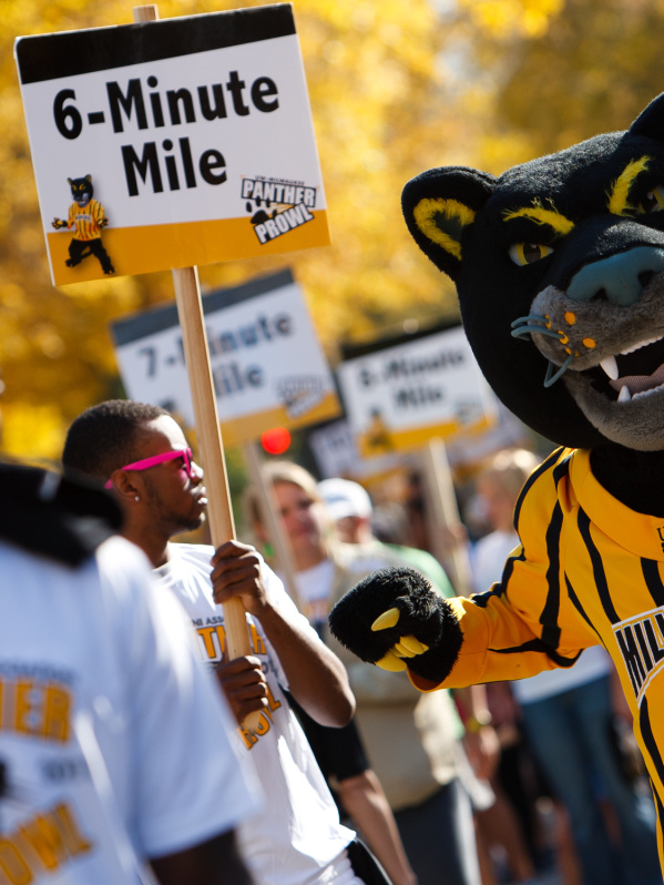 university of wisconsin milwaukee panther mascot cheering on runners for panther prowl