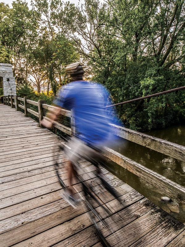 man biking over bridge in Hoyt Park