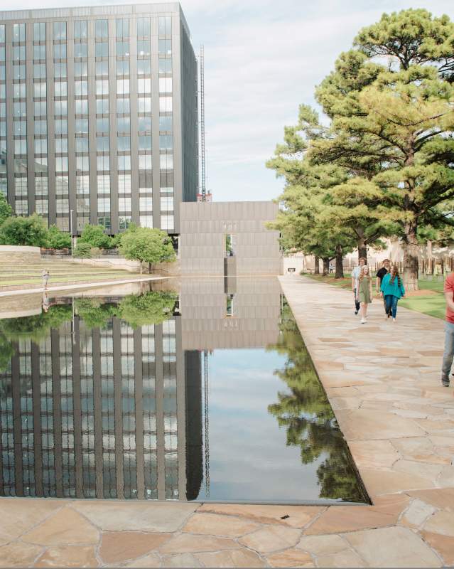Woman in wheelchair being pushed by a man the Memorial at the Oklahoma City National Memorial & Museum
