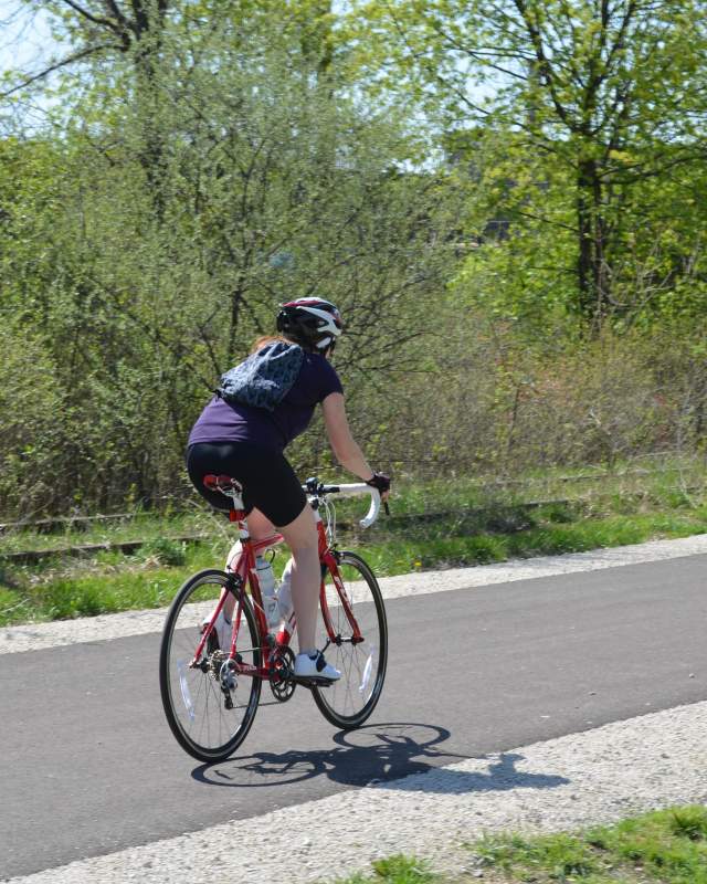 Woman riding a bike on a bike path in Akron, Ohio