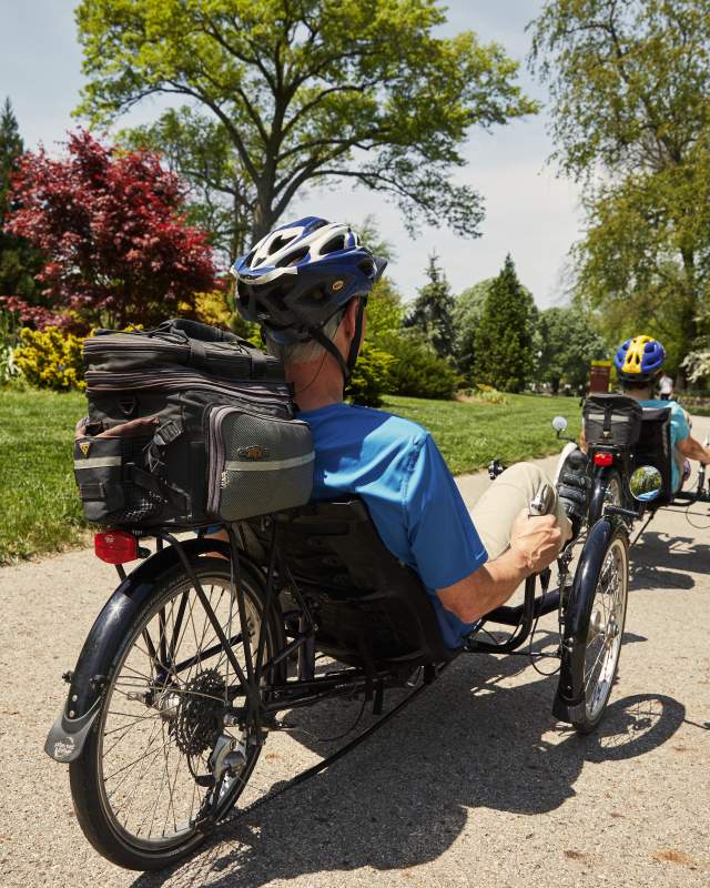 Man and woman biking with adaptive sports equipment