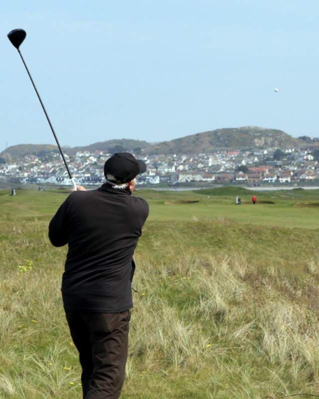 A golfer teeing off at Conwy Golf Club