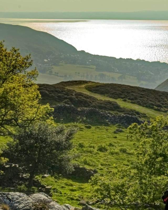 View of two walkers looking out over Sychnant Pass