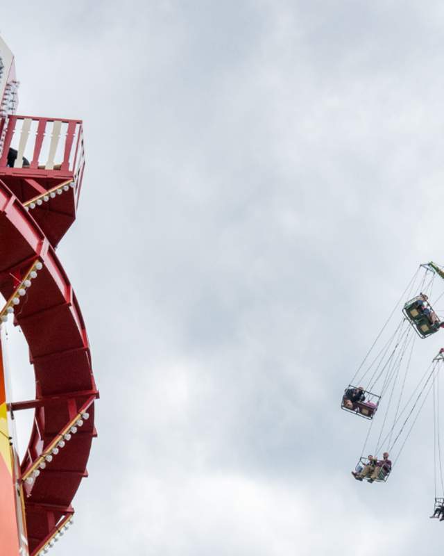 Image of hight flying swings and a helter skelter