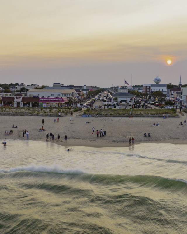 An aerial view of Rehoboth Beach and Rehoboth Beach Boardwalk at sunset.
