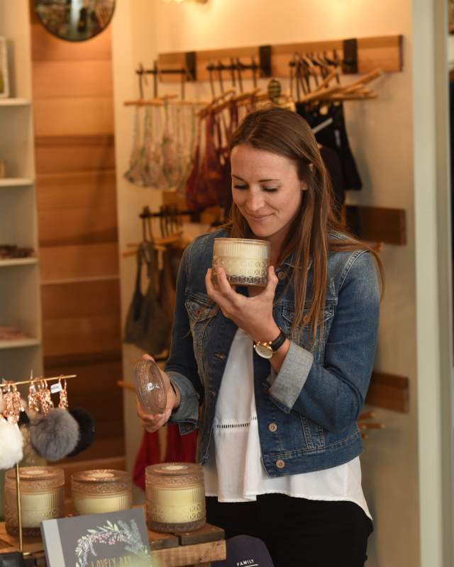 Woman smelling a candle while shopping