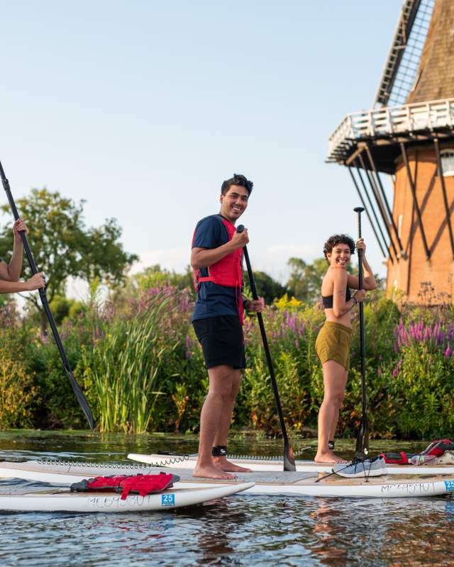 Group paddleboarding at Windmill Island Gardens