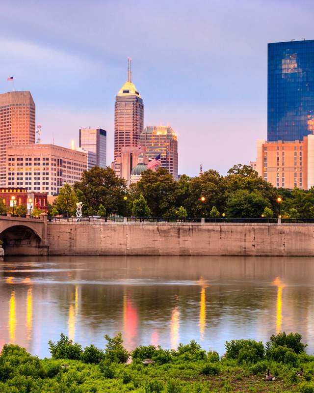 The White River reflects the Indianapolis skyline