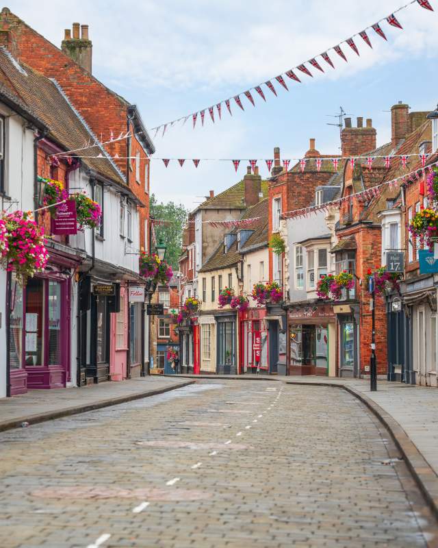 A view down the Bailgate, a historic street lined with colourful shops