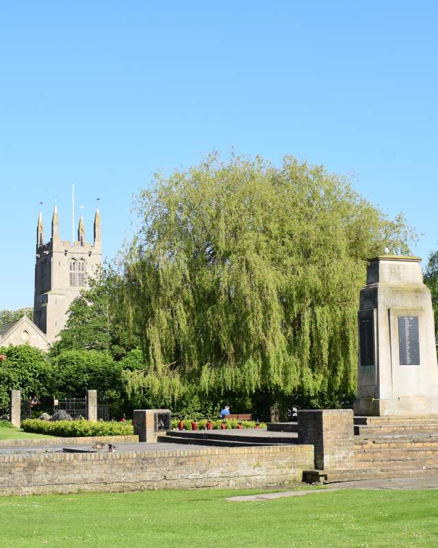 A landscape of Bourne Church and memorial with clear skies