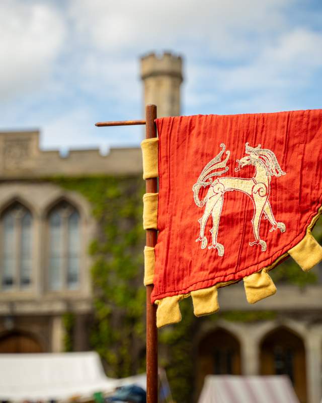 Red Festival of History flag outside Lincoln Castle in sunshine