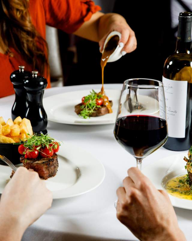 A group of friends enjoying a fine dining steak night