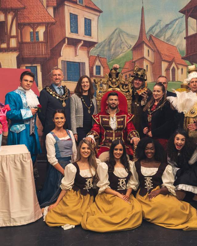 The cast of the Beauty and the beast pantomime smiling together.