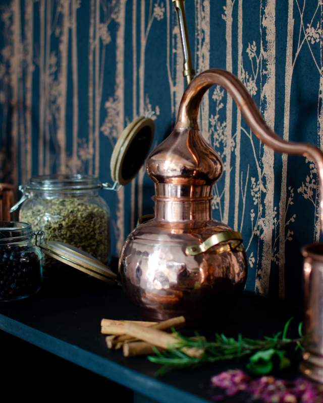 Gin distillery equipment displayed on a shelf.