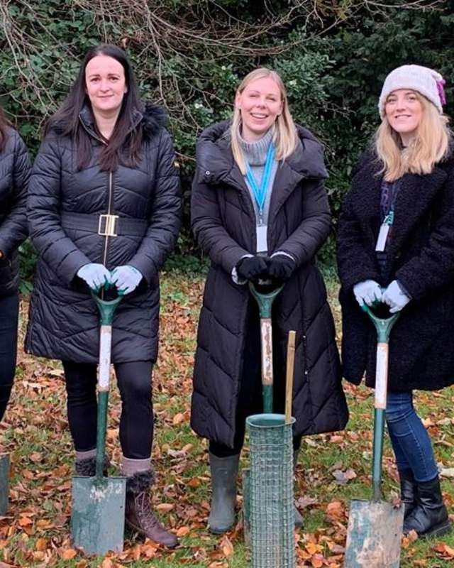 The Conference & Events Team at Hinxton Hall Conference Centre line up to get started with tree planting at the Wellcome Genome Campus