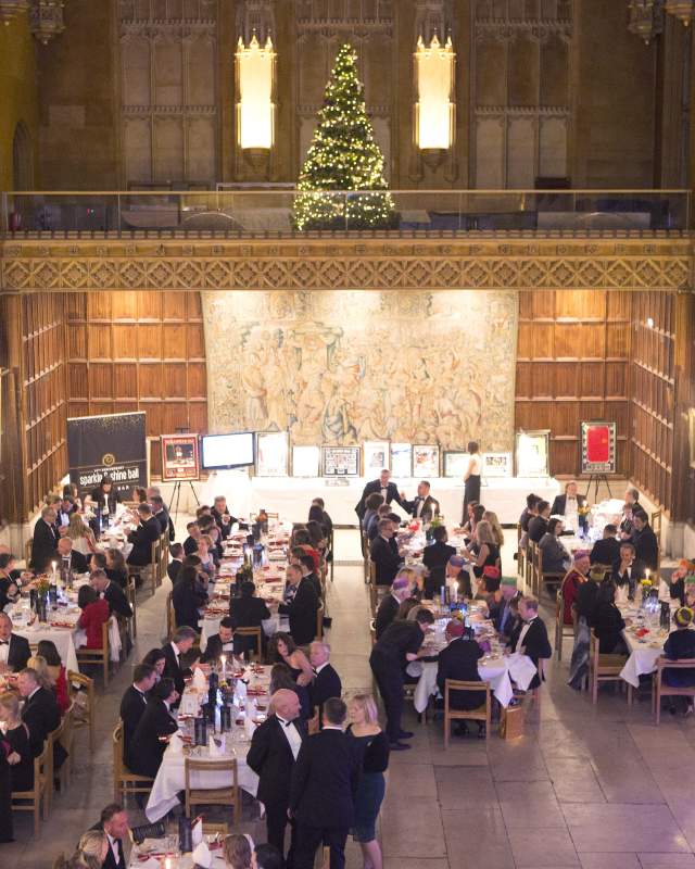 A group of people celebrating Christmas at King's College Cambridge as part of their office end of year celebrations