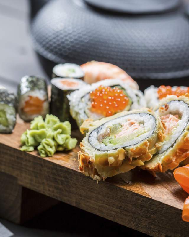 Closeup of fresh sushi on wooden board