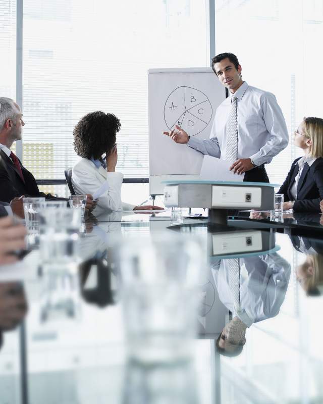 Group of office workers in a boardroom presentation