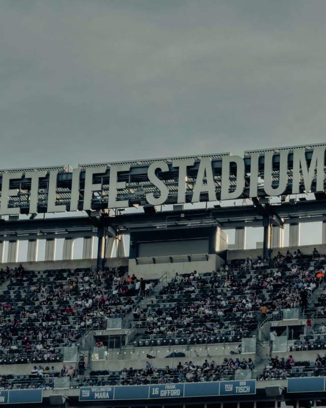 MetLife Stadium upper seating area filled with fans beneath large stadium signage in New Jersey during a live event