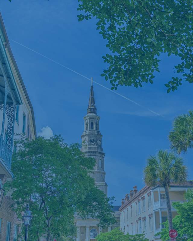 St. Philip’s Church with colorful buildings in Charleston, South Carolina.