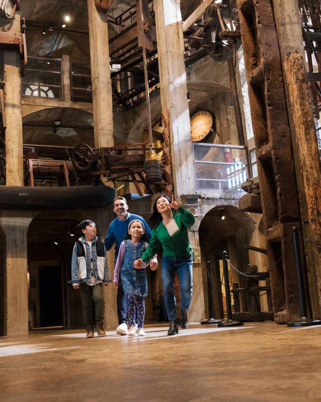 A family of four walking through a museum