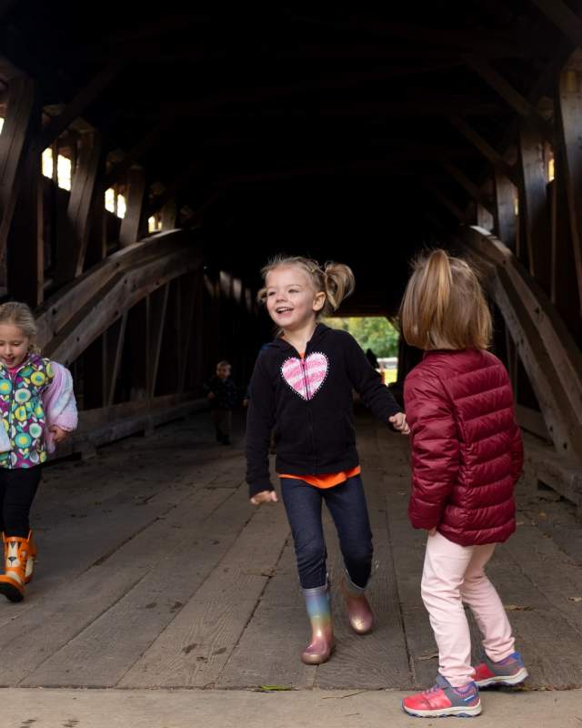 kids running on covered bridge