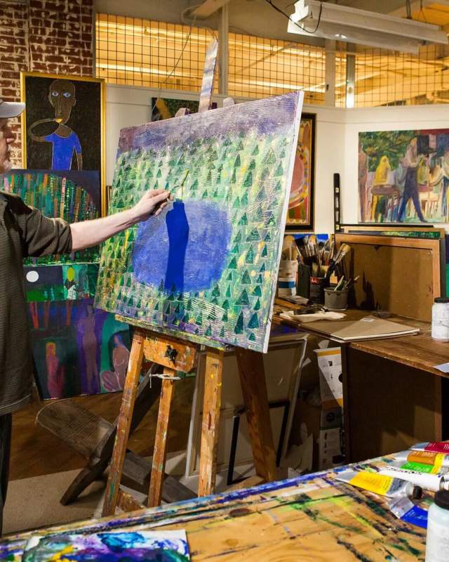 Artist painting at GoggleWorks Center for the Arts