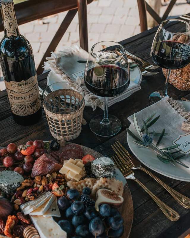 Wine and cheese platter displayed outdoors