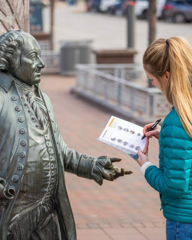 Woman filling out the City of Presidents Scavenger Hunt