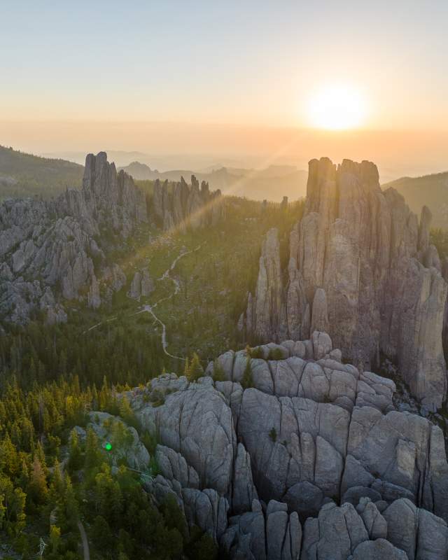 sun rays over the needles of needles highway in custer state park in south dakota