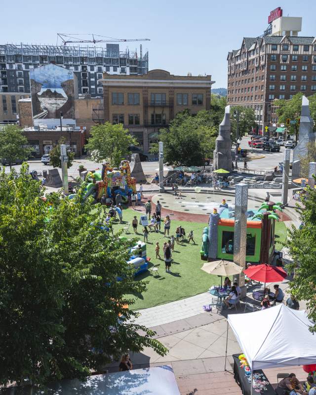 Image overlooking Main Street Square filled with waterslides and bouncy houses for kids in in Rapid City, SD