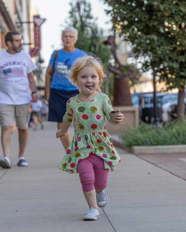 Little girl running in downtown Salina, Kansas