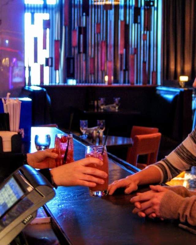 Two girls getting drinks at a bar