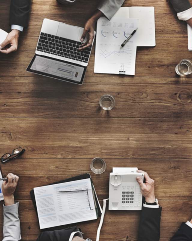Overhead view of multiple people working at table
