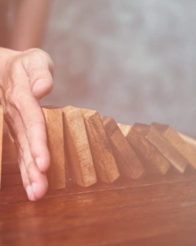 hand blocking dominoes