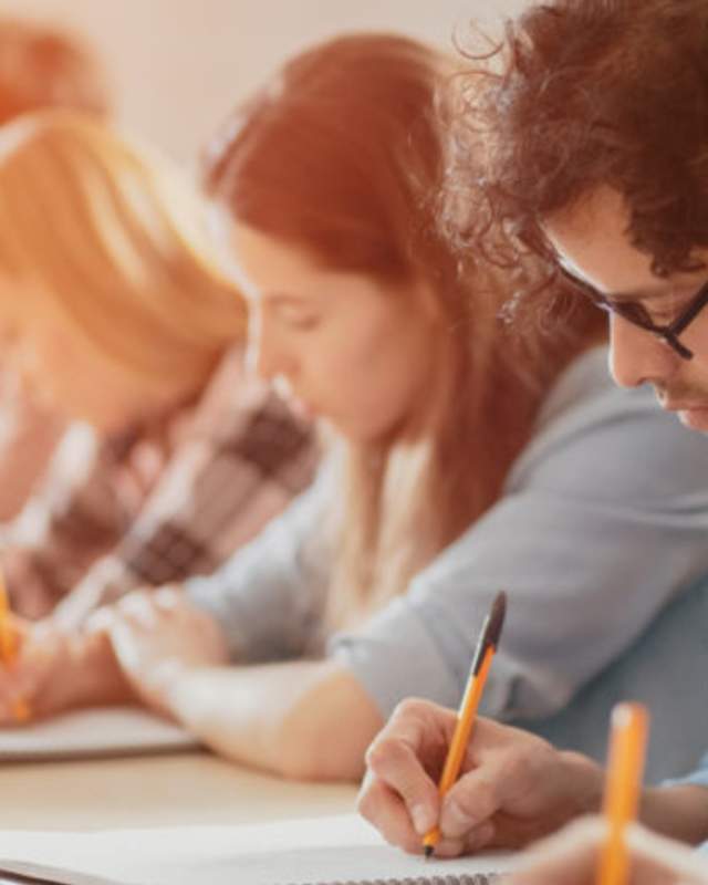 people writing at table