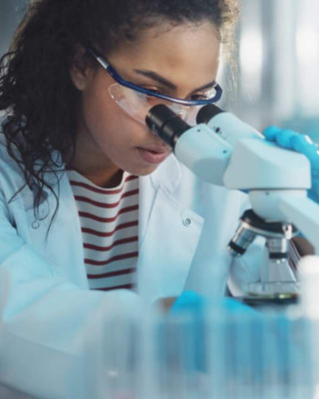 Person Using Microscope