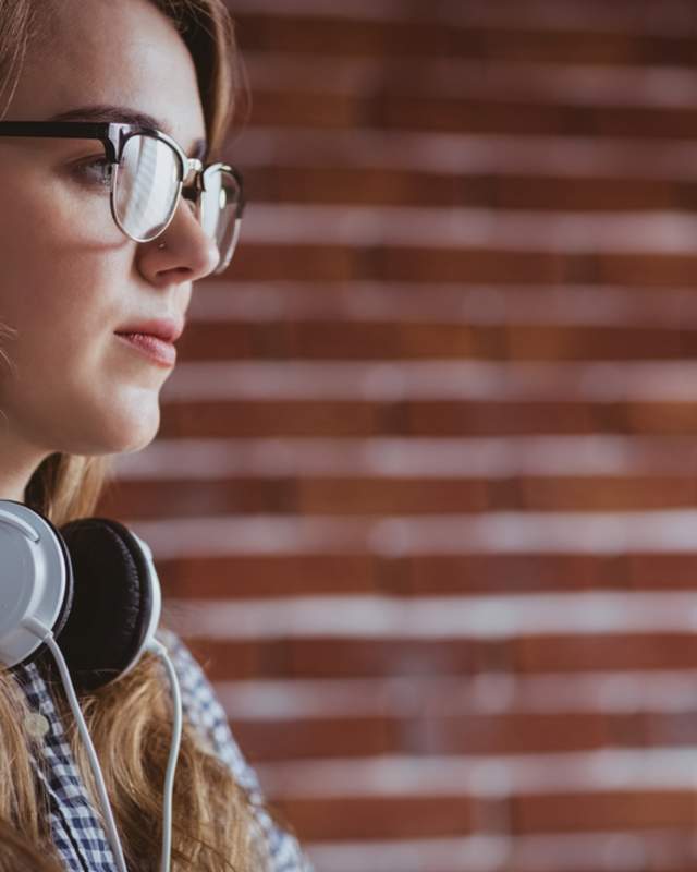 Woman with headphones around neck
