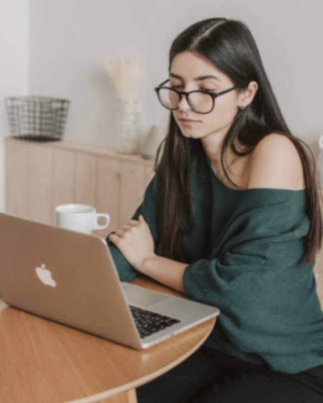 woman using laptop at table