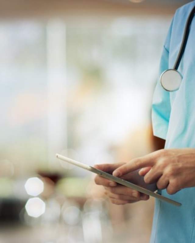 medical staff using tablet