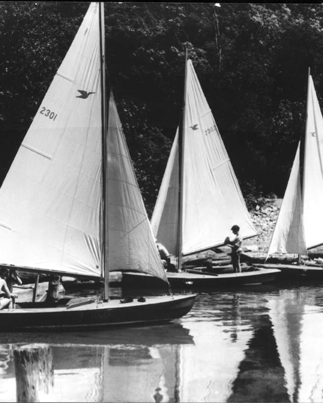 An antique picture of children on sailboats