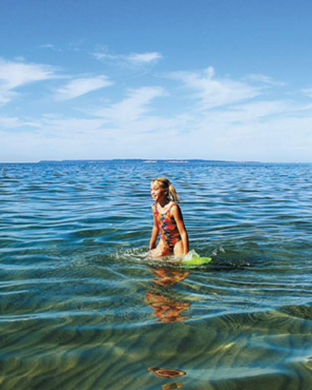 A girl standing in Lake Michigan