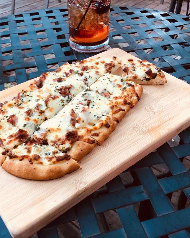 flatbread pizza on an outdoor table