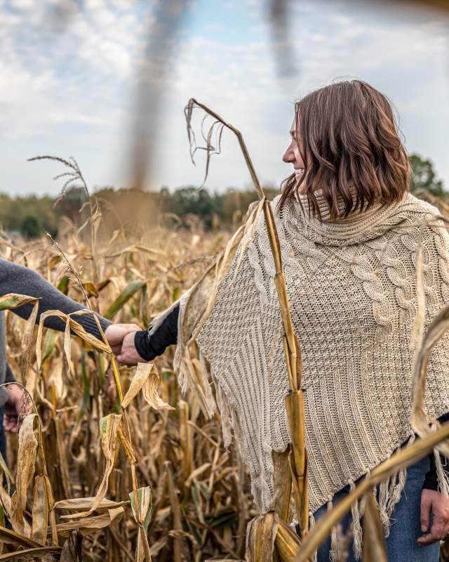 couple walking through corn maze