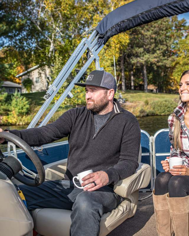 couple on pontoon ride on trego lake